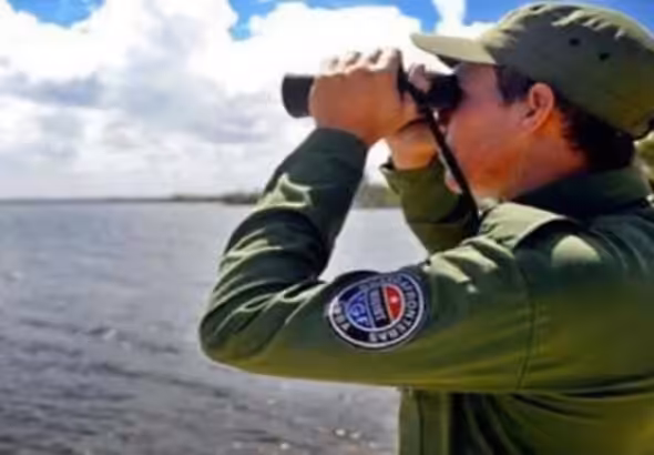 A member of the Cuban Border Guard observes the sea with his binoculars. File photo.