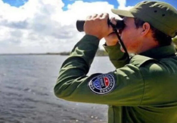 A member of the Cuban Border Guard observes the sea with his binoculars. File photo.