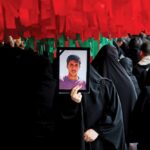 An Iranian woman holds the photograph of a youth killed by US-backed rioters. Photo: Tehran Times.
