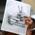 A Venezuelan woman holding, in a Jan. 28 demonstration, a sketch photo with the victory sign popularized by President Nicolas Maduro after being kidnapped by the US on Jan. 3, 2026. Photo: IG/@kimberly_meki.