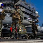 US Navy Captain Daniel Keeler, commanding officer of the aircraft carrier USS Abraham Lincoln, prepares to fly an MH-60R Sea Hawk helicopter in the Indian Ocean, January 23, 2026. Photo: US Navy/handout photo.