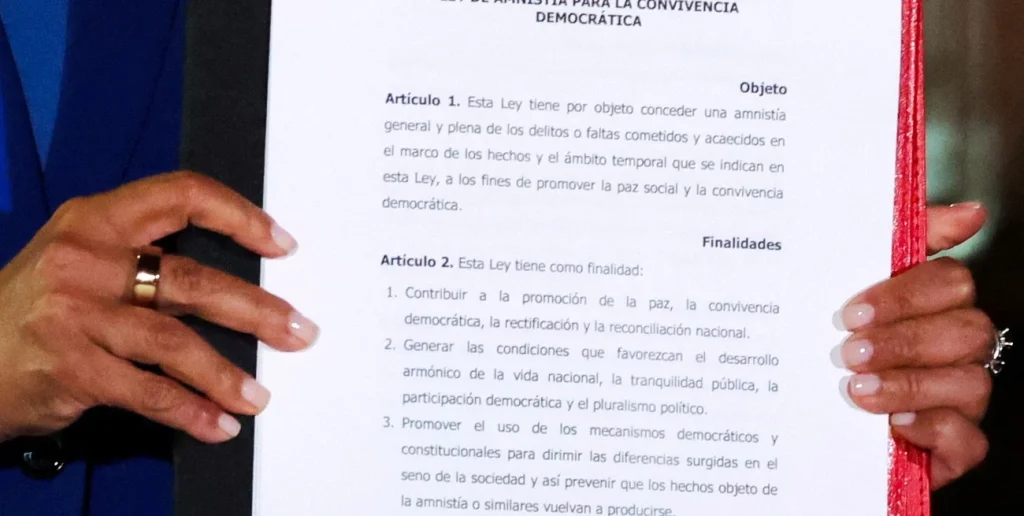 Venezuela's Acting President Delcy Rodriguez holds the text of the just-signed Amnesty Law at Miraflores Palace on Thursday, February 20, 2026. Photo: Reuters.