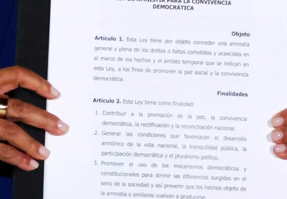 Venezuela's Acting President Delcy Rodriguez holds the text of the just-signed Amnesty Law at Miraflores Palace on Thursday, February 20, 2026. Photo: Reuters.