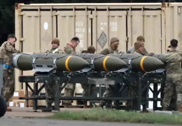 US Air Force personnel load munitions onto bombers at RAF Fairford in southwest England ahead of strikes on Iran, on 10 March 2026. Photo: Henry Nicholls/AFP.
