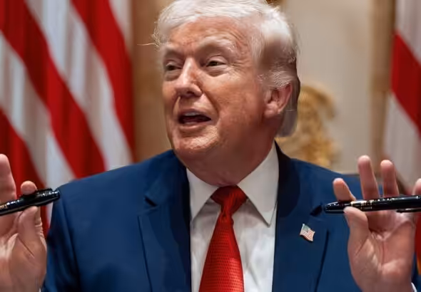 President Donald Trump holds up two Sharpie pens as he speaks during a Cabinet meeting at the White House, March 26, 23036, in Washington. Photo: AP.