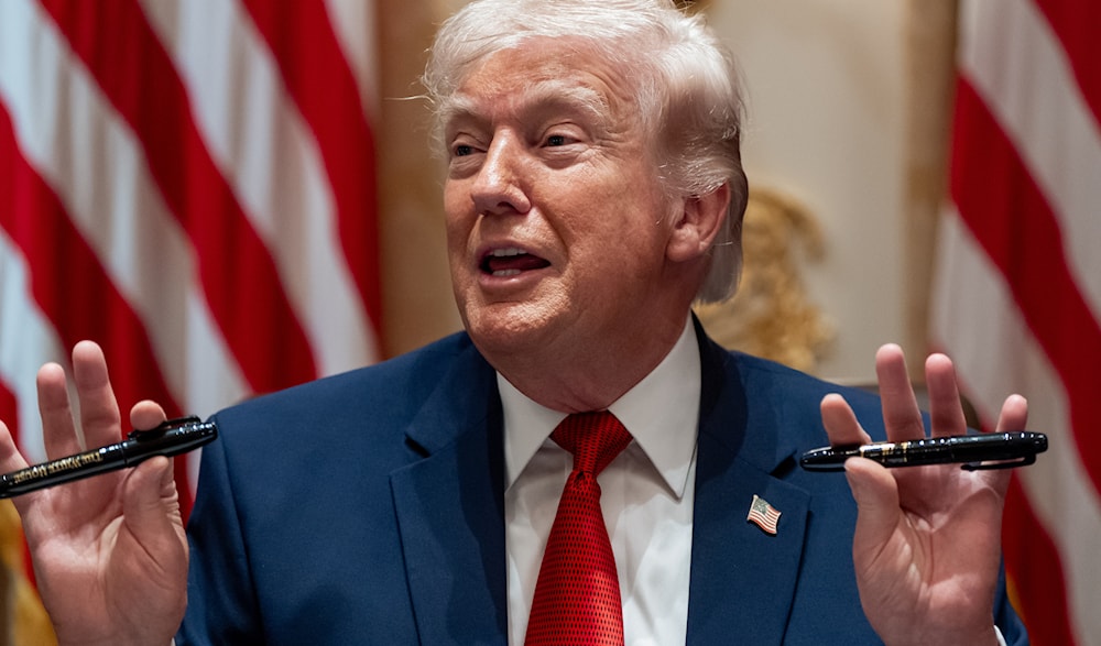 President Donald Trump holds up two Sharpie pens as he speaks during a Cabinet meeting at the White House, March 26, 23036, in Washington. Photo: AP.