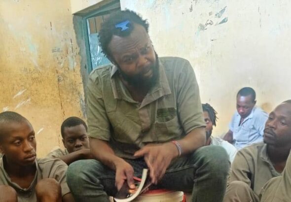 Kenyan communist leader Booker Omole educating inmates in a prison cell. Photo: X/@BookerBiro.