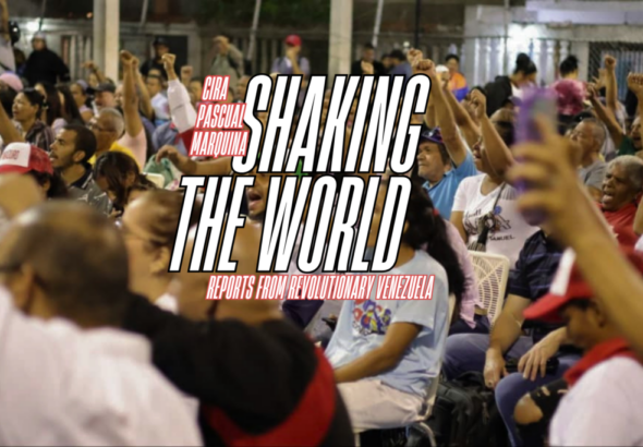 Venezuelan commune members with their arms raised at a meeting. Photo: Monthly Review.