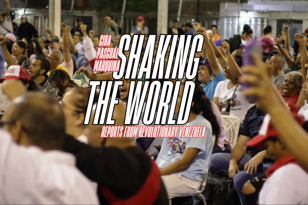 Venezuelan commune members with their arms raised at a meeting. Photo: Monthly Review.