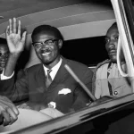 Patrice Lumumba smiles and waves from a car. Photo: RT/File photo.
