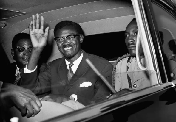 Patrice Lumumba smiles and waves from a car. Photo: RT/File photo.