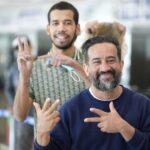 Repatriated Venezuelan migrant does President Nicolas Maduro's victory sign, popularized after the US kidnapping, while waiting to pass migration in the Simón Bolívar International Airport in Maiquetía, La Guaira state, on March 11, 2026. Photo: IG/@minjusticia_ve.