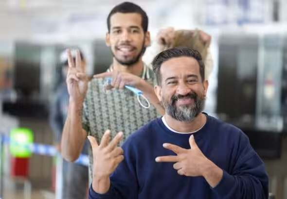 Repatriated Venezuelan migrant does President Nicolas Maduro's victory sign, popularized after the US kidnapping, while waiting to pass migration in the Simón Bolívar International Airport in Maiquetía, La Guaira state, on March 11, 2026. Photo: IG/@minjusticia_ve.