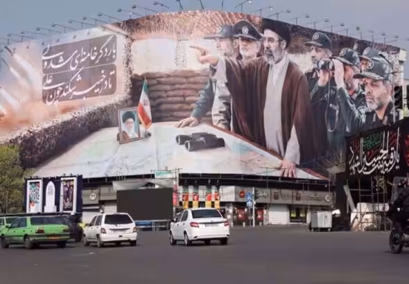 Cars pass a banner featuring Iran's new Supreme Leader Mojtaba Khamenei, amid the US-Israeli conflict with Iran, in Tehran, Iran, March 14, 2026. Majid Asgaripour/WANA.