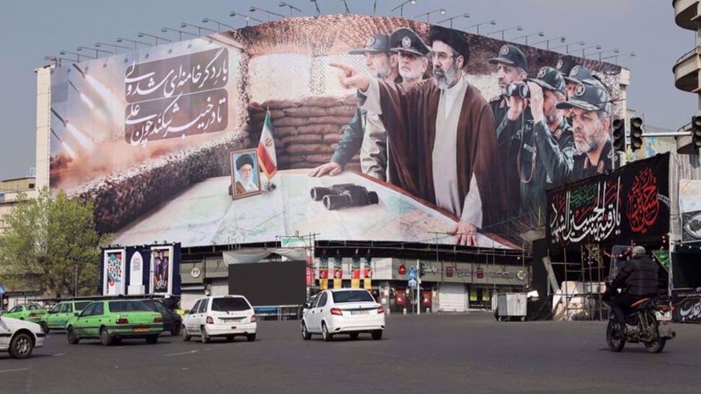 Cars pass a banner featuring Iran's new Supreme Leader Mojtaba Khamenei, amid the US-Israeli conflict with Iran, in Tehran, Iran, March 14, 2026. Majid Asgaripour/WANA.