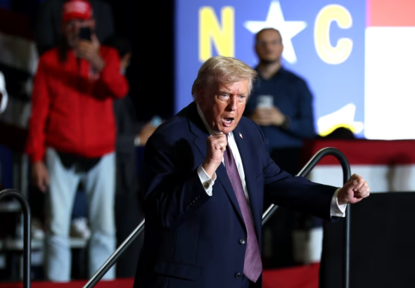 US Regime Dictator Donald Trump dances on stage during a rally at the Rocky Mount Event Center in Rocky Mount, North Carolina on December 19, 2025. Photo: Tasos Katopodis/Getty Images.