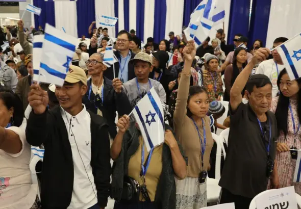 Members of the Bnei Menashe (Sons of Manasseh) community from India wave Israeli flags as they arrive at Ben Gurion Airport in Lod, near Tel Aviv, on April 23, 2026. Photo: Jack Guez/AFP.