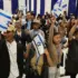 Members of the Bnei Menashe (Sons of Manasseh) community from India wave Israeli flags as they arrive at Ben Gurion Airport in Lod, near Tel Aviv, on April 23, 2026. Photo: Jack Guez/AFP.