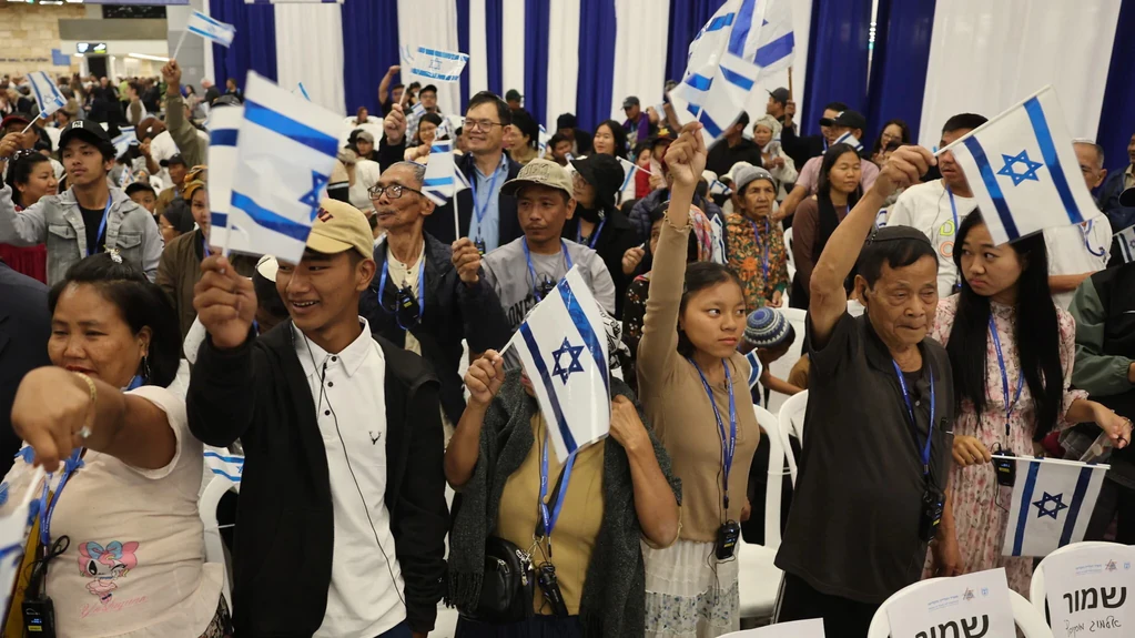 Members of the Bnei Menashe (Sons of Manasseh) community from India wave Israeli flags as they arrive at Ben Gurion Airport in Lod, near Tel Aviv, on April 23, 2026. Photo: Jack Guez/AFP.