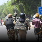 Police charge during a protest by workers over wage hike demands in Noida, India. Photo: Sunil Ghosh/Getty Images/Hindustan Times.