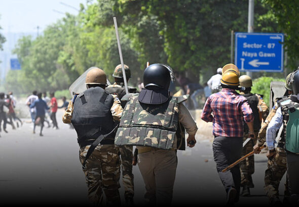 Police charge during a protest by workers over wage hike demands in Noida, India. Photo: Sunil Ghosh/Getty Images/Hindustan Times.