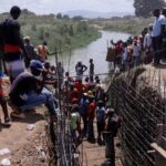 Haitian volunteers work on the Ouanaminthe canal on the Djabon river, on the border with Dominican Republic. Photo: Reuters/Octavio Jones.