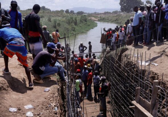 Haitian volunteers work on the Ouanaminthe canal on the Djabon river, on the border with Dominican Republic. Photo: Reuters/Octavio Jones.