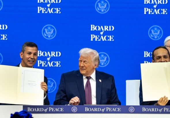 Paraguayan President Santiago Peña holding up a document at the Board of Peace in January 2026. Photo:  X/@SantiPenap.