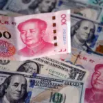 US dollar and Chinese yuan bills. Photo: Sheldon Cooper/Zuma Press.