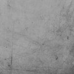 A weathered and scratched grey surface with a distinct grunge texture. Photo: The Philosophical Salon.