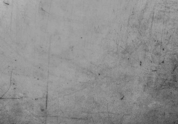 A weathered and scratched grey surface with a distinct grunge texture. Photo: The Philosophical Salon.
