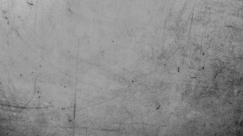 A weathered and scratched grey surface with a distinct grunge texture. Photo: The Philosophical Salon.