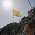 A Hezbollah flag flies over the ruins of an Israeli airstrike in the southern Beirut suburb of Dahiye al-Salam, April 13, 2026. Photo: PressTV.
