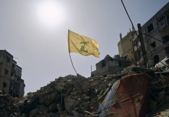 A Hezbollah flag flies over the ruins of an Israeli airstrike in the southern Beirut suburb of Dahiye al-Salam, April 13, 2026. Photo: PressTV.