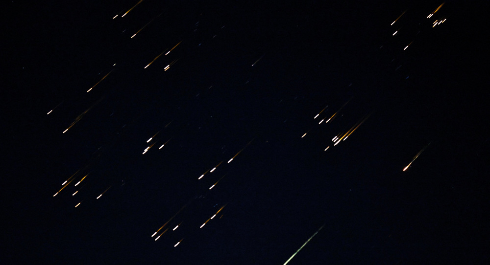 Bright fragments streak across the sky in what local media described as a missile with a split warhead, amid the U.S.-Israeli war on Iran Iran, as seen from Asqalan in occupied Palestine, March 5, 2026. Photo: Reuters.