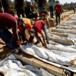 People bury the unidentified bodies of Palestinians who had been held in Israel during the war, after they were handed over by Israel in Deir Al-Balah, central Gaza, on 22 October 2025. Photo: Reuters/Mahmoud Issa.