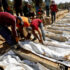 People bury the unidentified bodies of Palestinians who had been held in Israel during the war, after they were handed over by Israel in Deir Al-Balah, central Gaza, on 22 October 2025. Photo: Reuters/Mahmoud Issa.