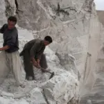Two workers working in a lithium quarry in Afghanistan. Photo: Jawed Kargar/DPA/Picture alliance.