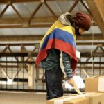 A Colombian voter, wearing a poncho with the colors of the Colombian flag, casts his ballot. File photo.