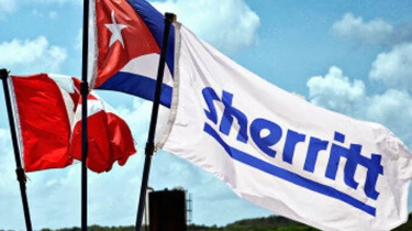 The photo composition shows three flags waving: Canada, Cuba, and Sherritt International. Photo: The Canadian Network on Cuba.