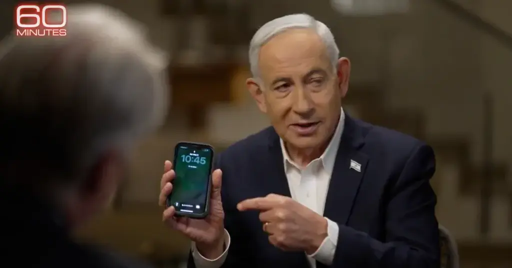 Benjamin Netanyahu holds up a mobile phone during an interview on 60 Minutes on May 11, 2026. Photo: Caitlin Johnstone/file photo.