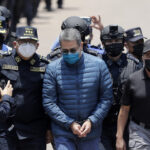 Former President of Honduras Juan Orlando Hernández is escorted by Honduran police to be extradited to the United States to face charges related to drug trafficking on April 21, 2022, in Tegucigalpa, Honduras. Photo: Jorge Cabrera/Getty Images/file photo.