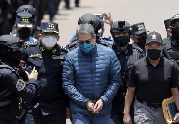 Former President of Honduras Juan Orlando Hernández is escorted by Honduran police to be extradited to the United States to face charges related to drug trafficking on April 21, 2022, in Tegucigalpa, Honduras. Photo: Jorge Cabrera/Getty Images/file photo.