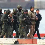 Venezuelan President Nicolás Maduro and his wife, National Assembly Deputy Cilia Flores, abducted from Venezuela by US special forces, in handcuffs after landing at a Manhattan helipad, escorted by heavily armed US Federal agents as they make their way into an armored car en route to a Federal courthouse in Manhattan on January 5, 2026 in New York City. Photo: XNY/Star Max/GC Images.