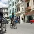 The image shows two Cubans riding bicycles on a street with little traffic. Photo: EFE.