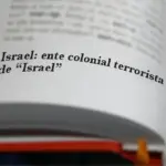 An open dictionary in which the entry Israel: colonial terrorist entity of "Israel" is highlighted. Illustration: Al-Mayadeen.