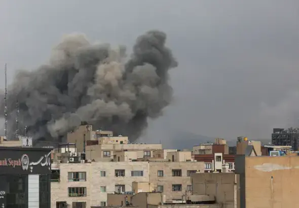 Smoke rising over the skyline of Tehran, Iran, following airstrikes conducted by the US Empire and its Zionist Entity in early March 2026. Photo: Reuters.