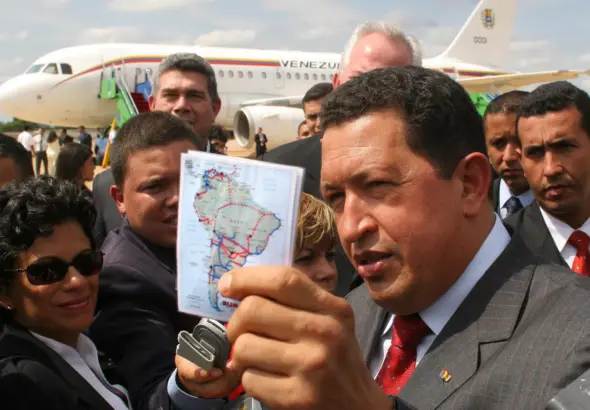 Former Venezuelan President Hugo Chávez holds up a map of the South American continent while responding to the press about Latin American regional unity in Mar del Plata, Argentina, November 2005. Photo: AP/Eraldo Peres.