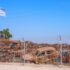 Israeli flag flies over a small portion of the vehicles that were attacked and burned on 7 October in the Gaza Envelope border area. Photo: Caitlin Johnstone/File photo