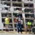 Emergency responders look at a heavily damage building in La Guaira state, Venezuela, after the June 24 double earthquake. Photo: AFP/file photo.